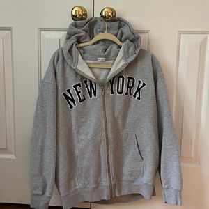 Brandy Melville grey “New York” zip up hoodie.